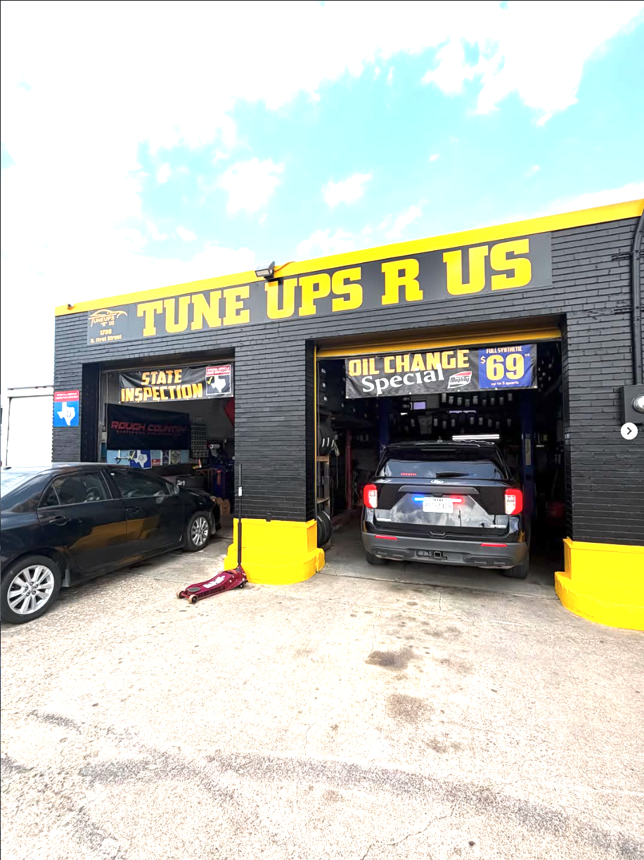 Tune Ups R Us shop front at 1738 S First St in Garland, Texas — black building with yellow TUNE UPS R US sign and two open service bays